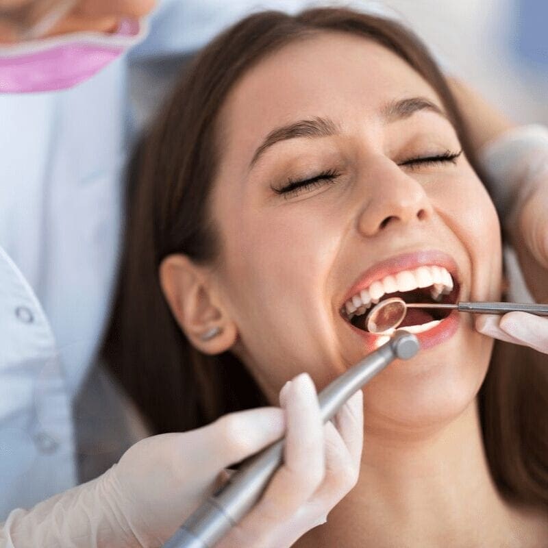 Woman at the dentist having teeth extraction procedure